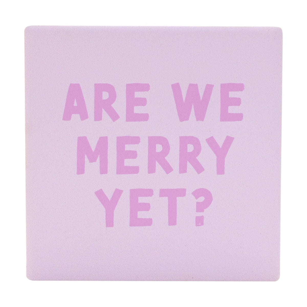 Square ceramic Christmas coaster in soft purple with "Are We Merry Yet?" printed in chunky orchid pink capitals, matt finish, shown on a plain white background.