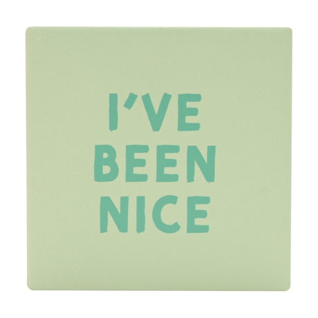 Square matt ceramic coaster in pale sage green with "I've Been Nice" in bold teal capitals, shown on a plain white background.