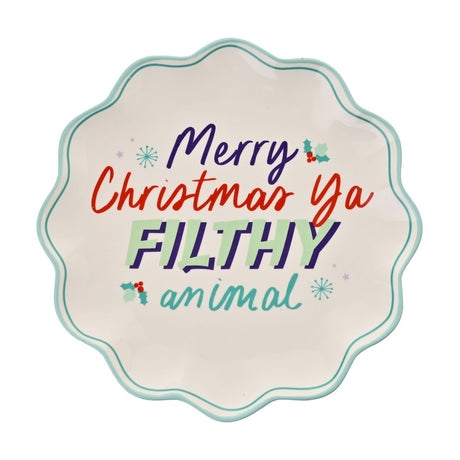 Round stoneware plate with wavy mint-green edge, white centre printed with "Merry Christmas Ya FILTHY animal" in purple, red, mint and teal, holly accents, on a plain white background.