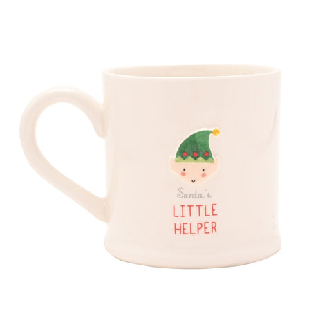 White stoneware mug with a raised Christmas elf face design, green hat with red bobbles, "Santa's Little Helper" text, C-shaped handle, on a plain white background.