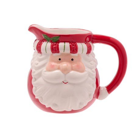 Ceramic milk jug from the Santa Lidded Stoneware Sugar Bowl set, shaped as Santa's face with white beard, red handle, and striped red-and-white band, on a plain white background.