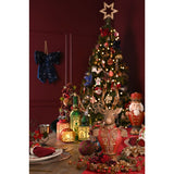 Reindeer Bust Figurine 30cm with gold antlers, red military-style jacket and gold scrollwork, displayed on a Christmas table setting near a decorated tree.