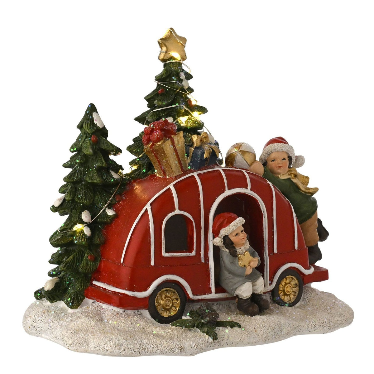 Red light-up Christmas caravan with gold wheels, presents and a star-topped tree on roof, two children in Santa hats nearby, on a snowy base.