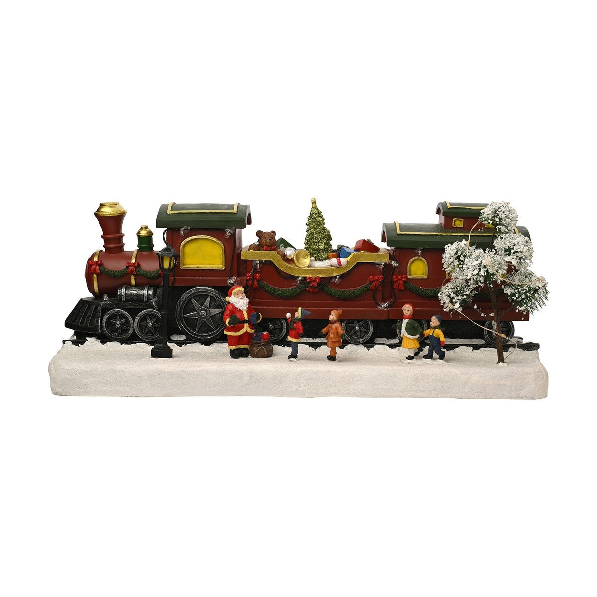 Christmas Train Scene light-up decoration with red steam engine, wagon of presents and teddy bear, carriages with green roofs, Santa and children figures on a snowy white base, plain background.