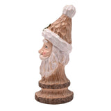 Side profile of the brown resin Wood Effect Santa Claus Bust Figurine, featuring a pointed hat with pompom, holly sprig, rosy cheeks, and flowing beard on a round base.