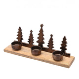 Christmas Tree Triple Tealight Metal Candle Holder in bronze, five metal tree silhouettes on a wooden base with three round tealight cups, set against a plain white background.