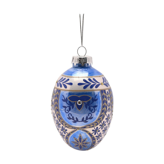 Oval painted glass egg Christmas tree decoration in blue and white, with gold leaf sprigs, a scrolling motif with clear sparkling stud, and a silver hanging loop, shown on a plain white background.
