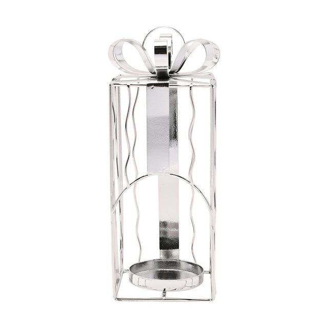 Silver iron tealight candle holder shaped like a Christmas present, with wavy wire sides, ribbon band, arched front opening, and a looped bow on top, shown on a white background.