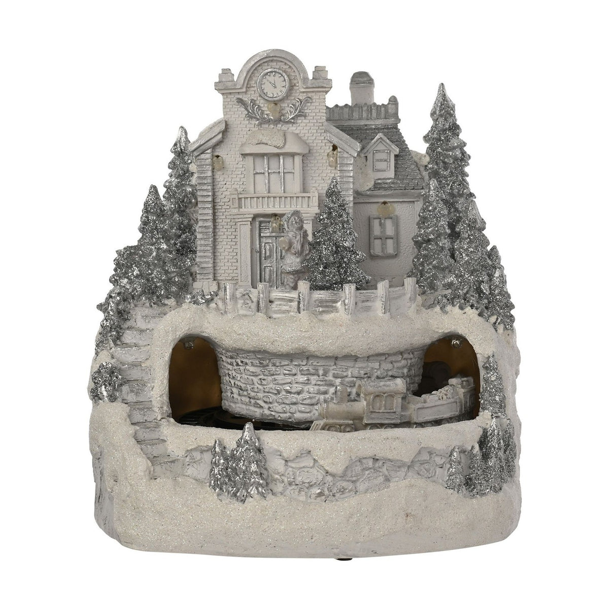 White resin Christmas village LED decoration with a clocktower building, smaller house, silver glitter pine trees, and a moving train through a tunnelled hillside base.