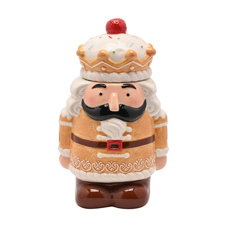 Gingerbread Nutcracker lidded ceramic biscuit barrel in brown, with a crown-shaped icing lid, moustache and beard detail, belt buckle, and boots, on a white background.