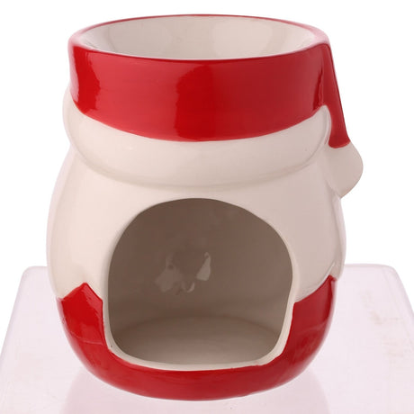 Ceramic wax melt burner shaped like Santa's hat, in red and white with a tealight opening at the front, shown on a plain white background.