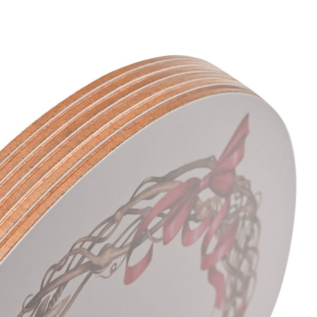 Close-up of a round placemat from the Robin Wreath set, showing layered wood edge finish and a watercolour-style wreath design in red and brown on a white surface.