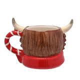 Ceramic Highland cow mug with textured brown fur body, cream horns, and red candy-cane striped handle and scarf base, shown on a plain white background.