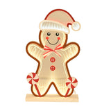 Infinity Gingerbread LED Light-Up Decoration, 34cm, shaped as a smiling gingerbread man with Santa hat, striped bow, red buttons and peppermint lollipops, on a wooden base against a white background.