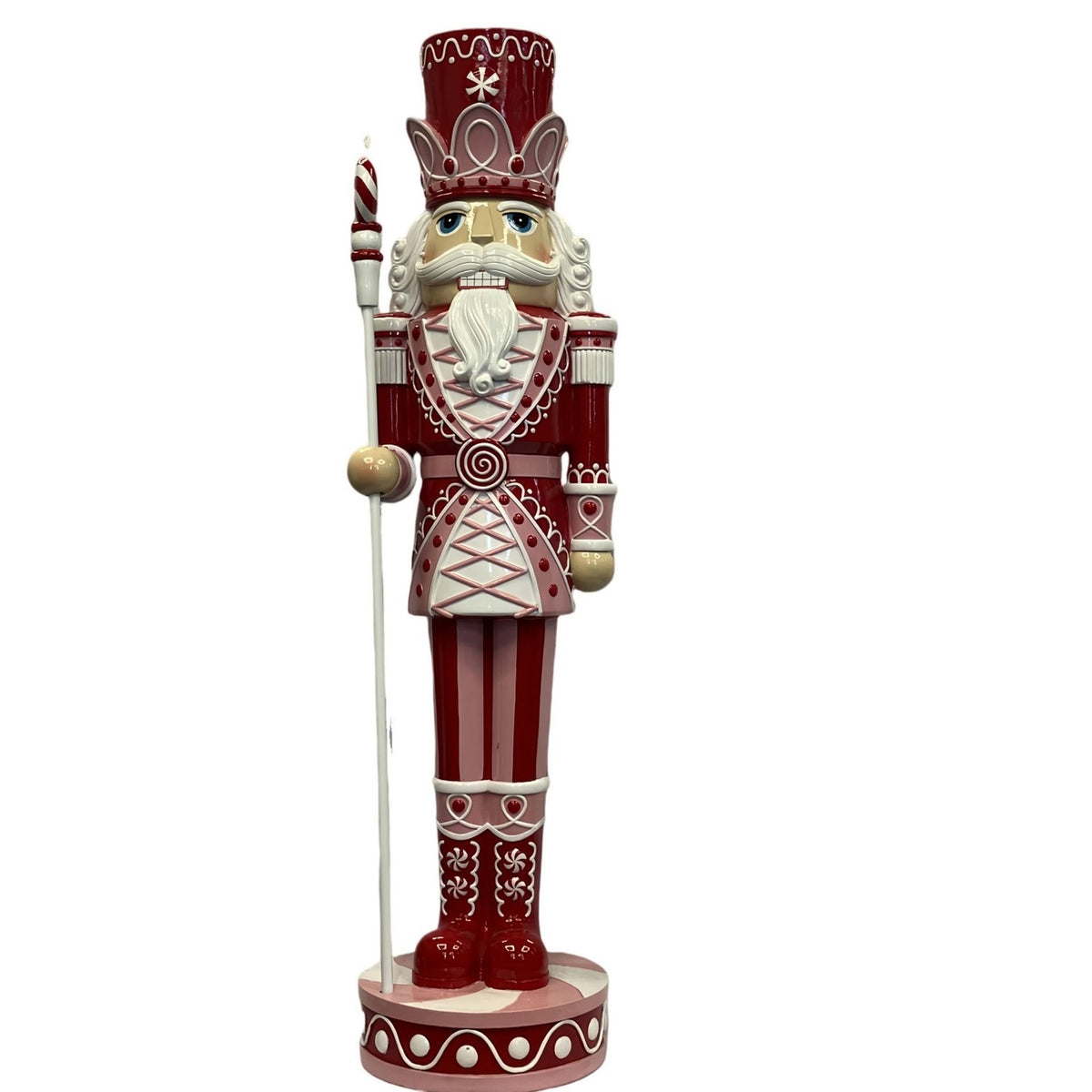 Giant resin Christmas nutcracker ornament, 92cm, in red and pink with white detailing, crown-banded hat, staff in hand, on round base against a plain white background.