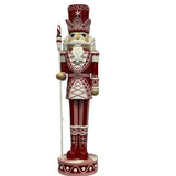 Giant resin Christmas nutcracker ornament, 92cm, in red and pink with white detailing, crown-banded hat, staff in hand, on round base against a plain white background.