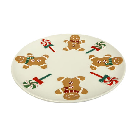 Round cream ceramic dinner plate, 19.5cm, featuring four smiling gingerbread men with icing trim and striped scarves alternating with red and green swirled lollipops, on a plain white background.