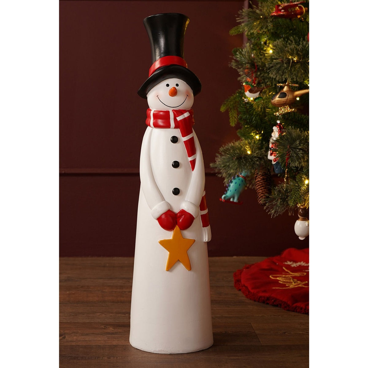 Tall white resin snowman garden ornament, 72cm, with black top hat, red striped scarf, red mittens holding a golden star, and black buttons, displayed beside a Christmas tree.
