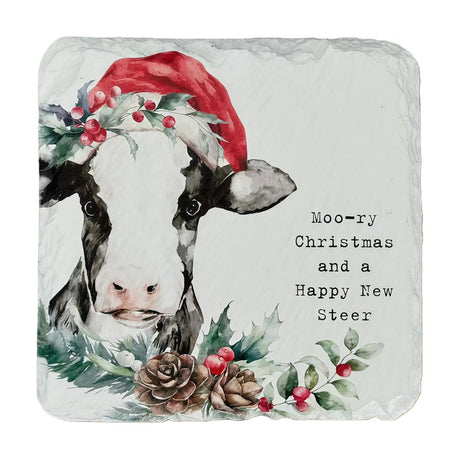 Square slate coaster featuring a watercolour black-and-white cow in a red Santa hat with holly and berries, pine cones below, and "Moo-ry Christmas and a Happy New Steer" text, on a white background.