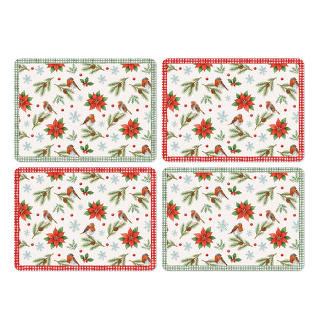 Set of four rectangular wood and cork placemats with a poinsettia, robin, holly and snowflake print on a pale ground, two bordered in green gingham and two in red gingham, shown on a white background.
