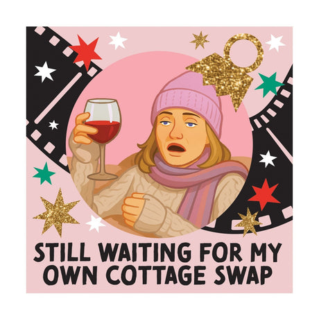 Square ceramic coaster on pink background, featuring a woman in a lilac beanie holding red wine within film reel and star graphics, captioned "Still Waiting For My Own Cottage Swap".