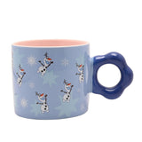 Blue porcelain Frozen mug with Olaf the snowman and snowflakes printed around, pink interior, and a scalloped deep blue ring handle, shown on a white background.