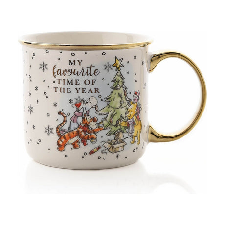 White ceramic mug with gold rim and handle, featuring Winnie the Pooh and friends decorating a Christmas tree beside "My Favourite Time of the Year" text, on a plain white background.