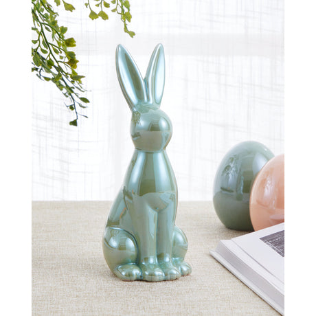 Yaypan Ceramic Rabbit Ornament in green, a seated figurine with tall upright ears and a glossy ceramic finish, displayed indoors near decorative eggs and foliage.