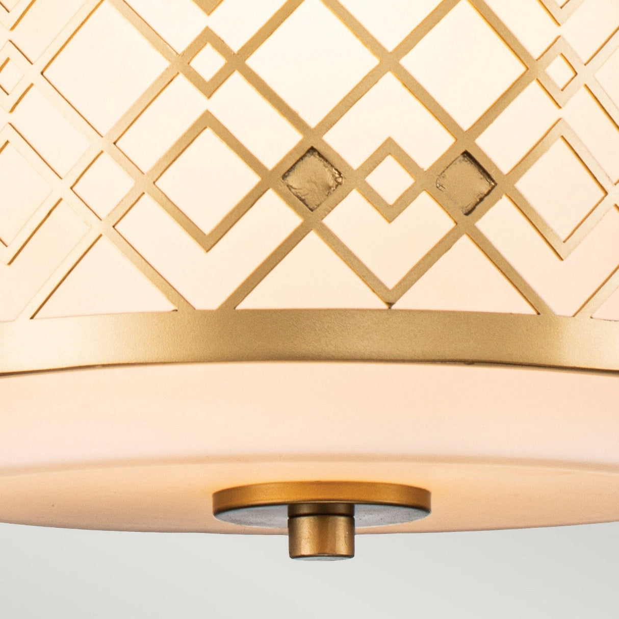 The Ziggy 1 Light Duo-Mount Small Pendant/Semi-Flush in lacquered gold showcases a geometric diamond design on frosted glass, featuring intersecting lines, small diamond shapes, and a central metallic knob underneath. This versatile lighting piece beautifully enhances any neutral background.