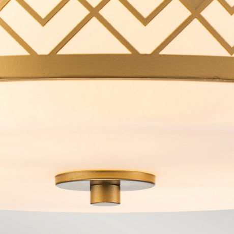 Close-up of the Ziggy 2 Light Medium Flush - Lacquered Gold ceiling fixture, showcasing a modern design with lacquered gold accents on a frosted glass surface. The fixture features intersecting lines creating diamond shapes and includes a central circular knob at the bottom.